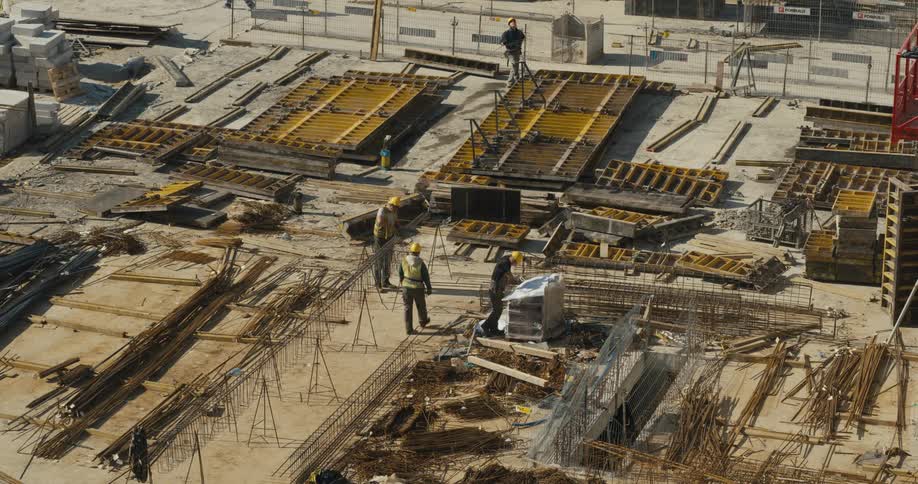 Construction workers walk through a site