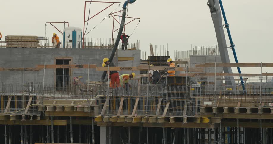 Construction workers are outdoors doing their job