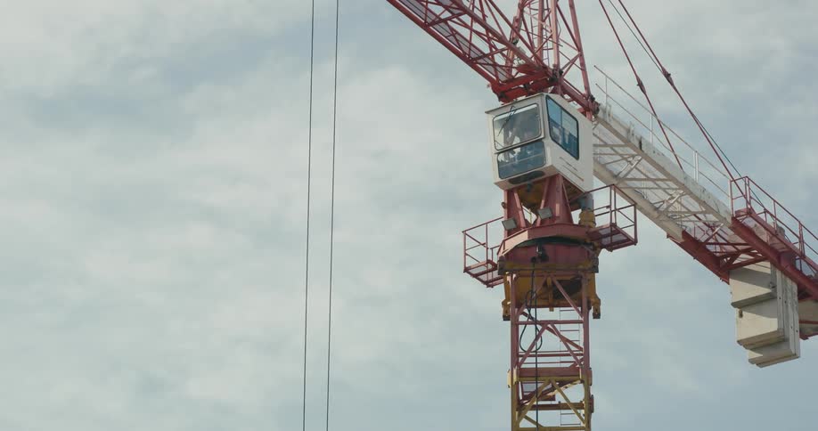 An employee is operating a construction crane