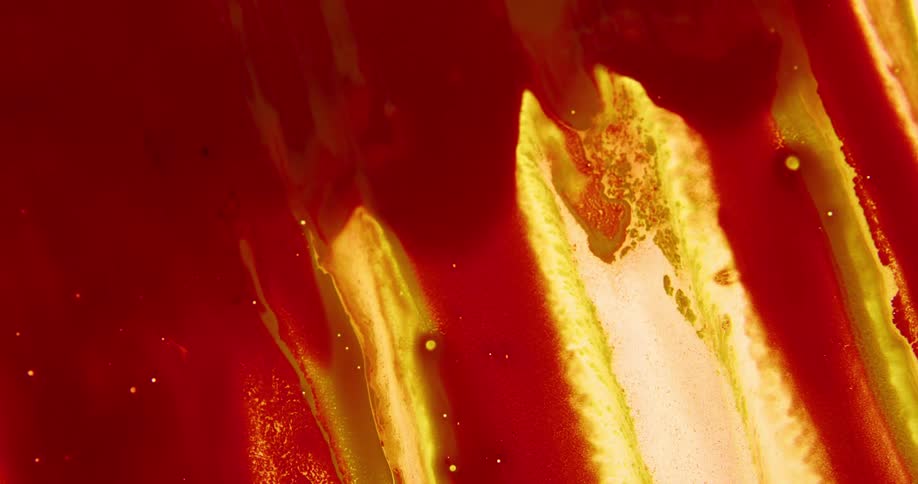 Thick blobs of liquid red ink flowing down a backlit translucent surface