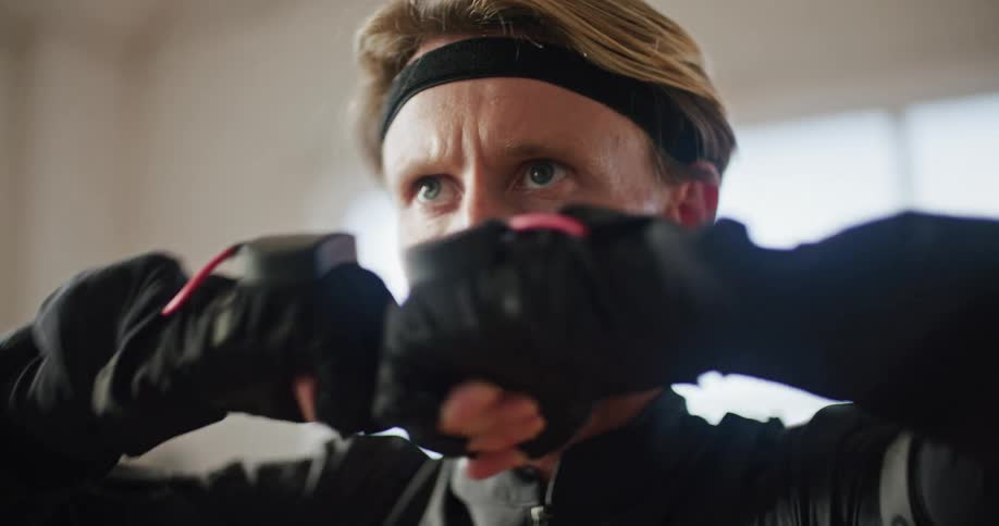 Man moves through combat poses while wearing motion sensors