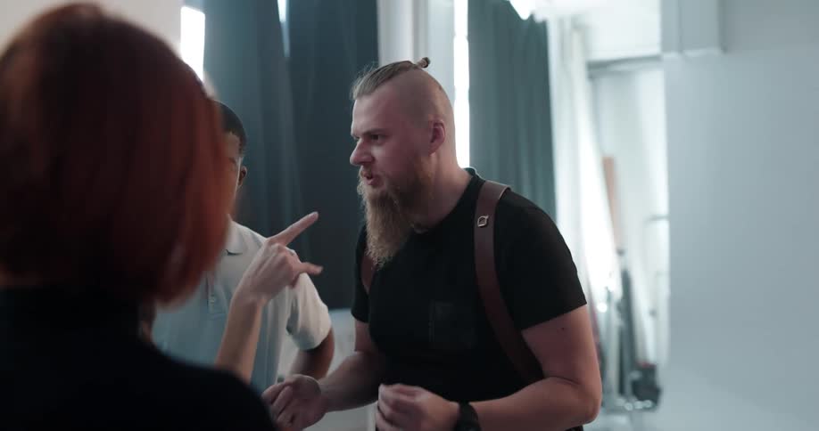 A group of four people are talking in a room together