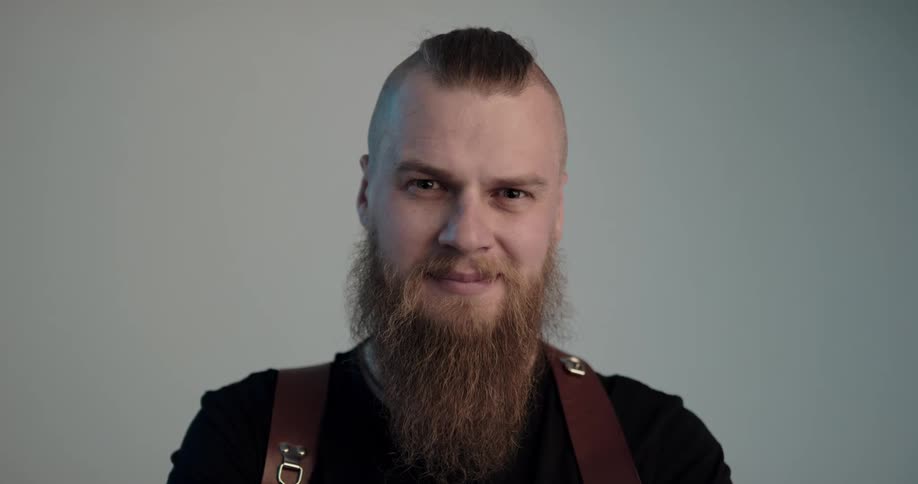 A man is posing for the camera and smiling