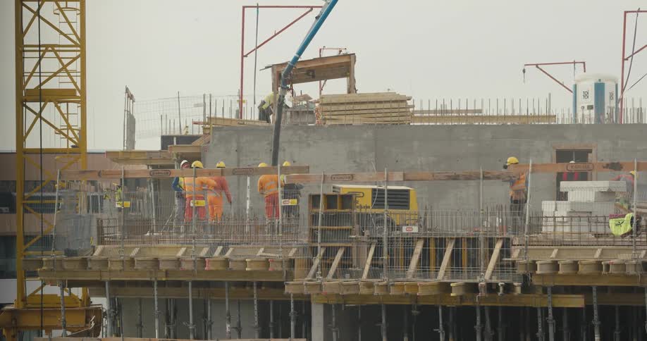 A group of construction workers are working together