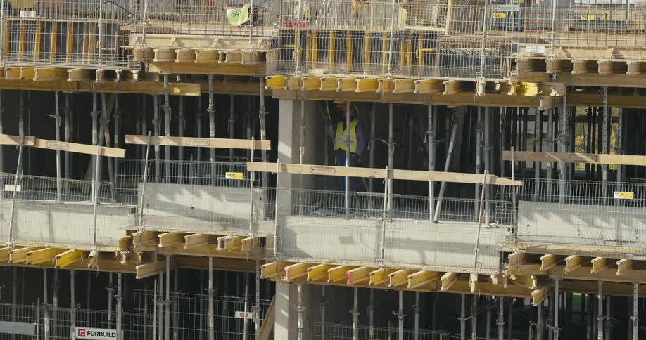 Construction crews work on a multi floor building