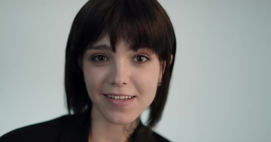 A woman smiles as she poses