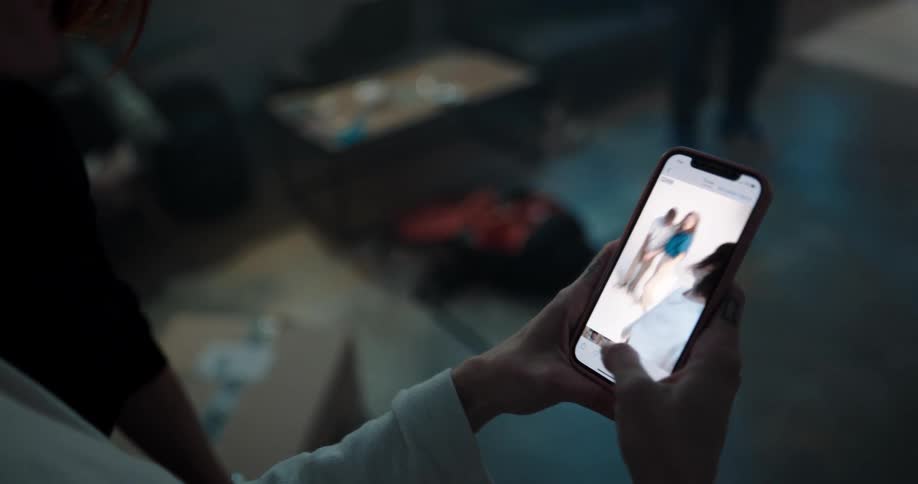 Woman reviews a video he made on her phone with models on a photo shoot
