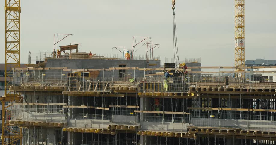 Construction worker employees are working outdoors at dusk