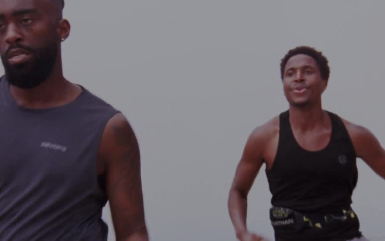 Three men running outdoors