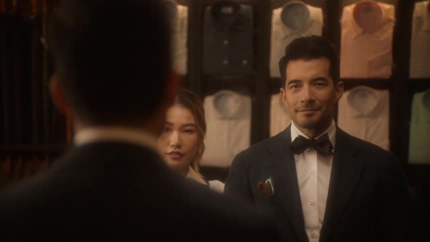 A man is getting fitted for a suit in a store