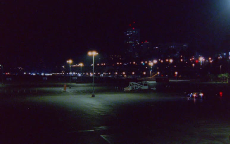 Empty parking lot in the city at night caught on vintage film