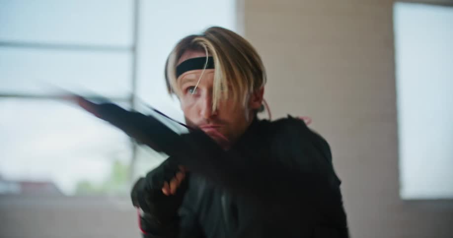A man punches and fights while using motion capture gloves