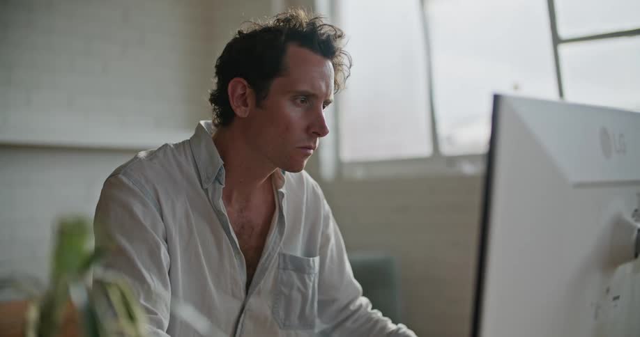 A man is sitting in front of a computer working