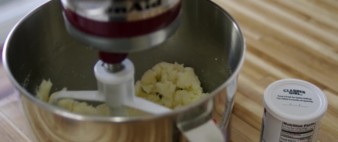 A mixer is stirring ingredients in a bowl
