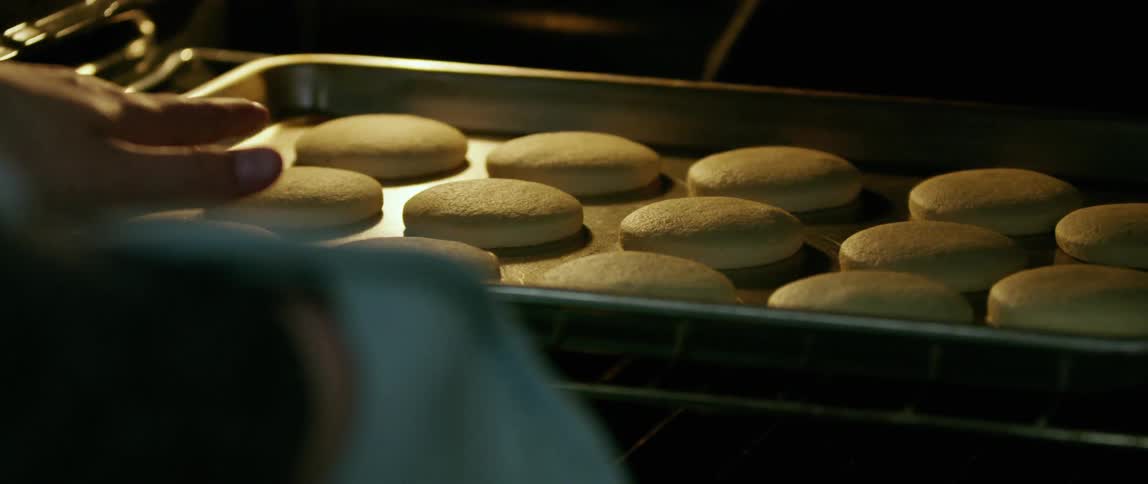 Someone tests the food in the oven for doneness before removing