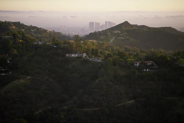 The hills have a few homes at the top