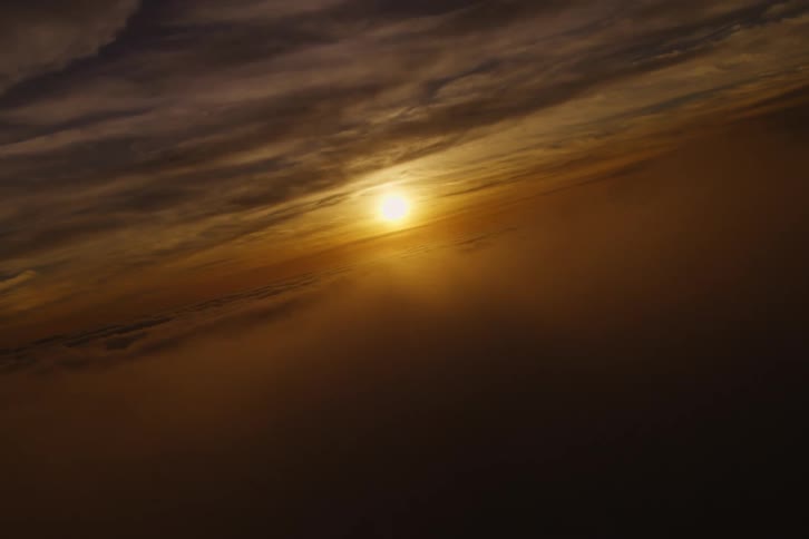 The sun is setting in the horizon at dusk