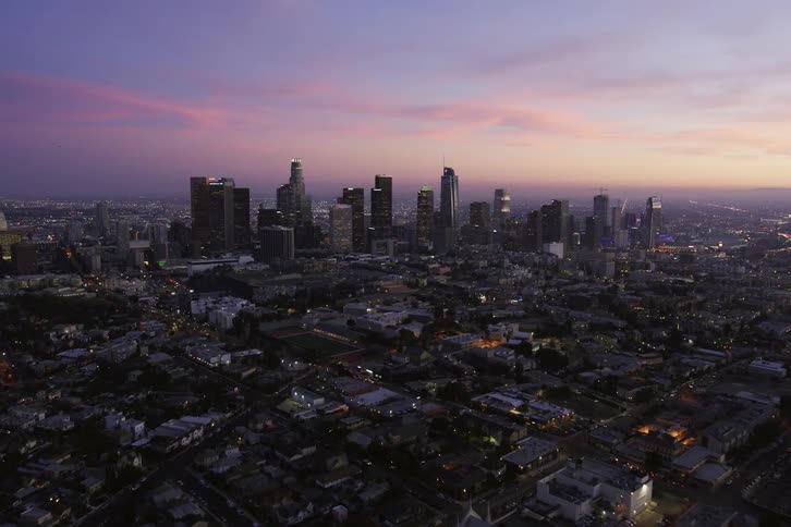 Aerial view of buildings in a city is displayed at dusk