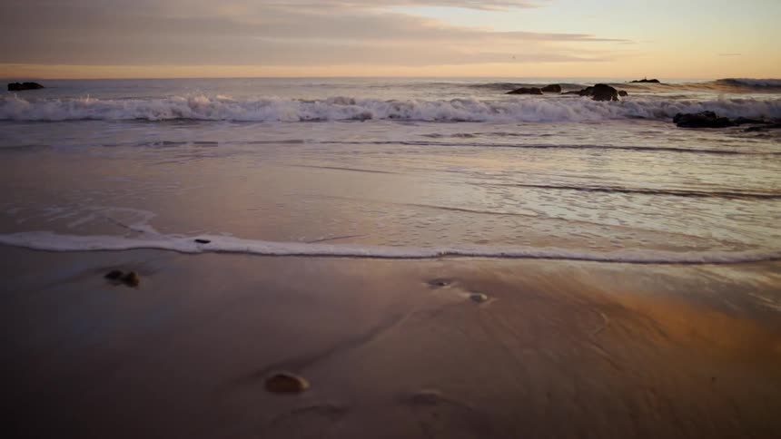 The sun is rising on the beach