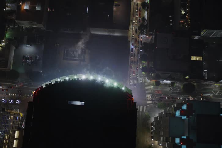 Heavy traffic passes through downtown at night