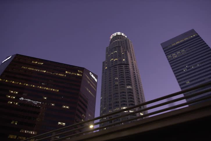 The tall buildings are lit at sunset