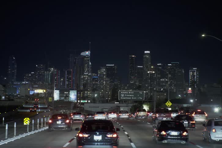 Vehicles travel on the highway towards the city