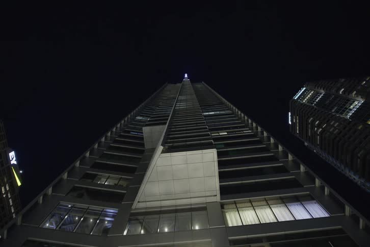 View of a downtown city at night is displayed on camera