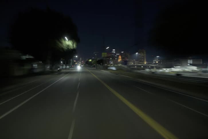 Vehicles travel on the city roads at night