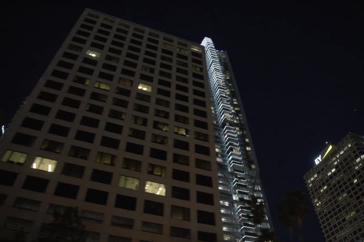 A city filled with skyscrapers are displayed at night