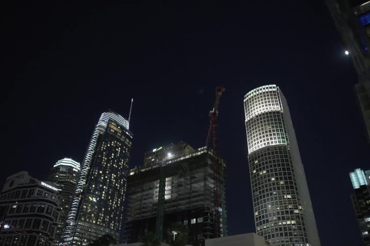 Tall buildings and skyscrapers under a clear night sky