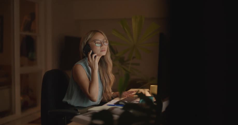 A woman talks on the phone in her office