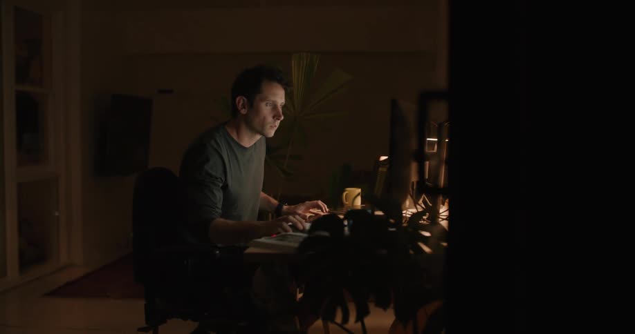 A man is working in home office at night