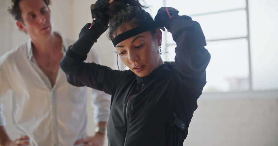 A woman puts on a wire harness