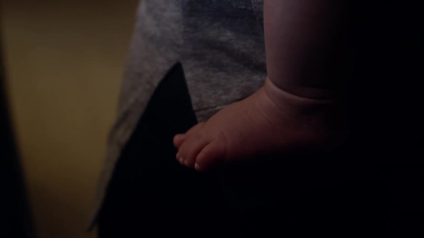 A person is holding a baby