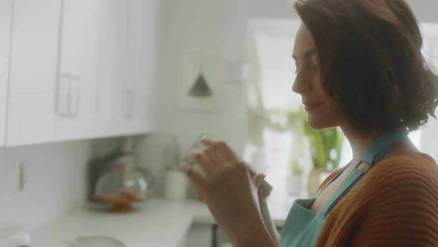A woman is taking pictures with her cellphone of food