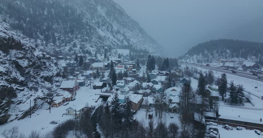 Aerial view of cars driving in a rural area during winter