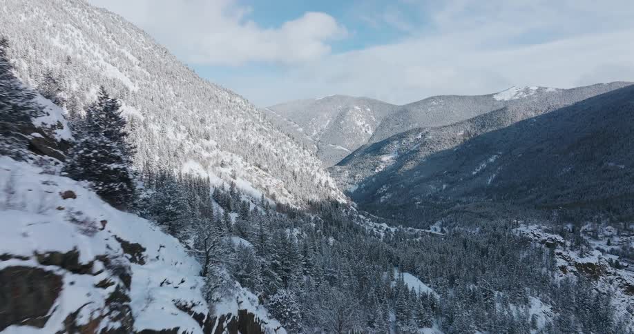Aerial view of snow covered mountains is displayed