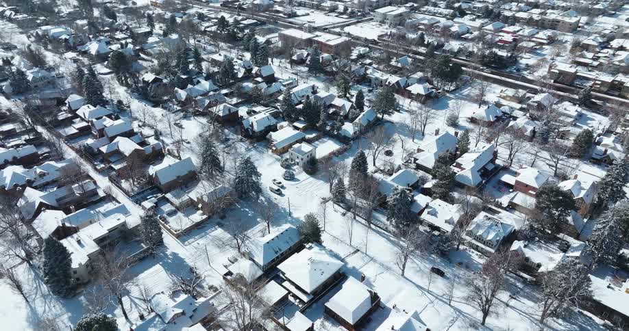 Aerial view of a neighborhood covered in snow at winter