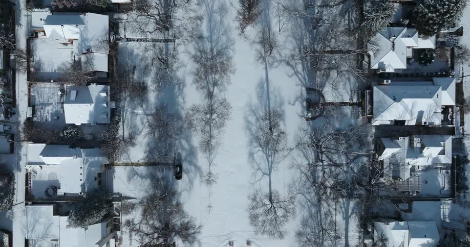 Aerial view looking down on a snow covered neighborhood on a winter day