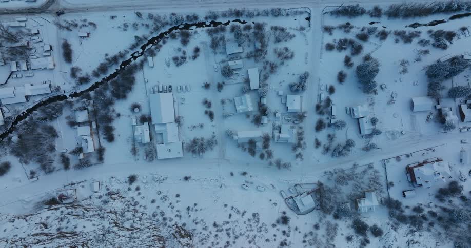 A thick blanket of snow covers a neighborhood