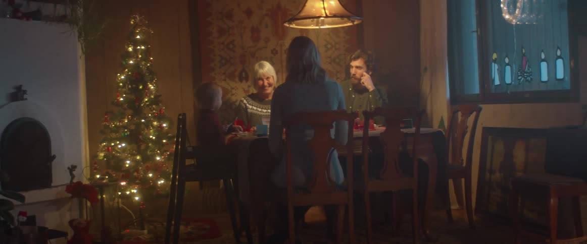 Family having the christmas dinner together inside the house