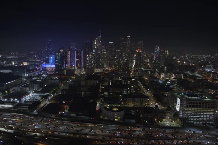 Aerial view of illuminated high rise buildings and skyscrapers at night