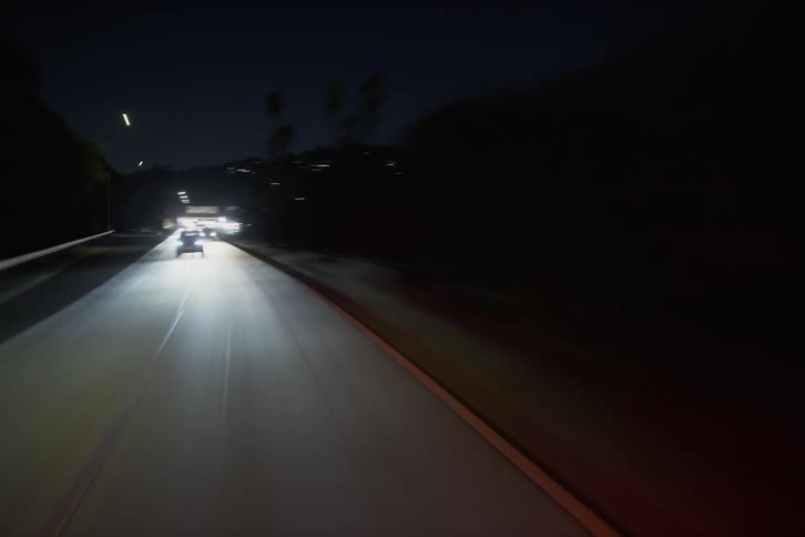 Time lapse of commuters on a freeway late at night