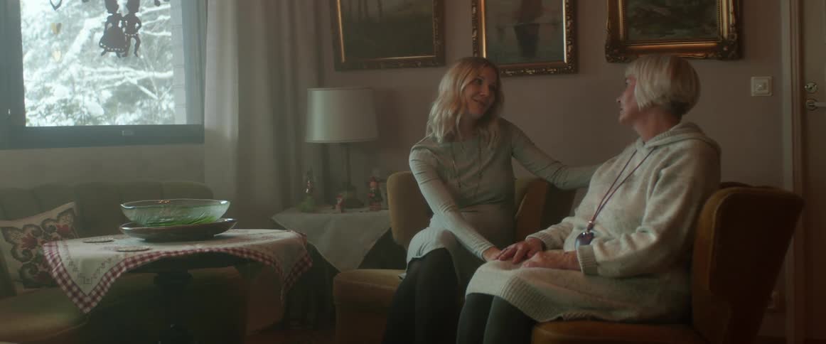 A mother is talking to her daughter in the living room