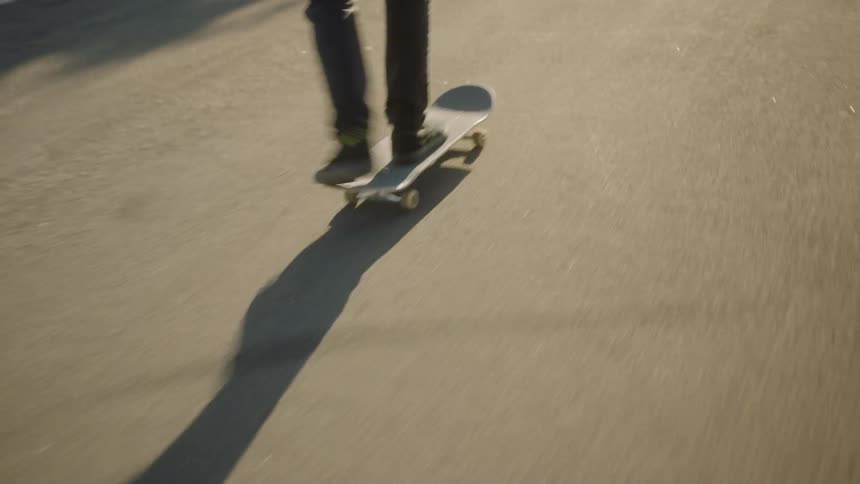 Skateboarder skating down neighborhood street attempts trick and fails