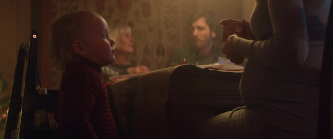 A baby is talking to his mother in the dining room