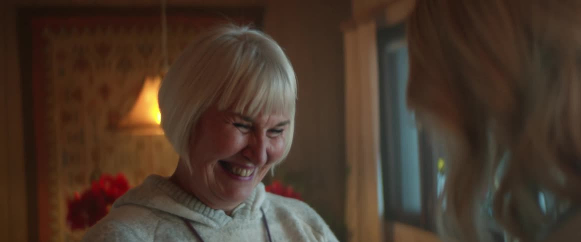 Two women are talking together and laughing