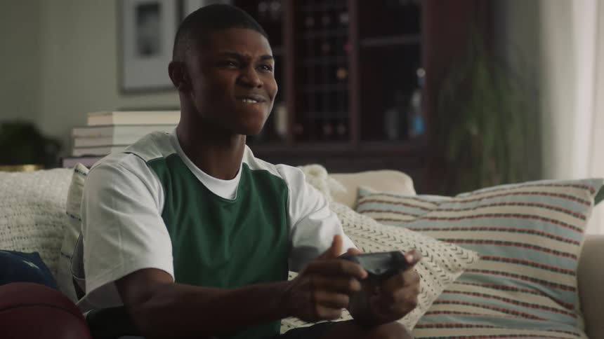 A boy is playing video games at home