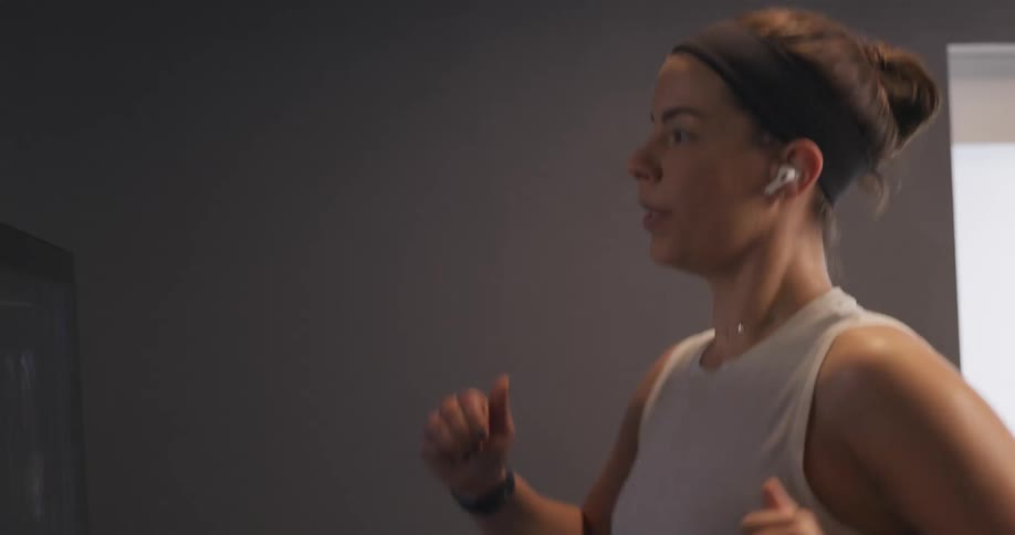 A woman is jogging indoors