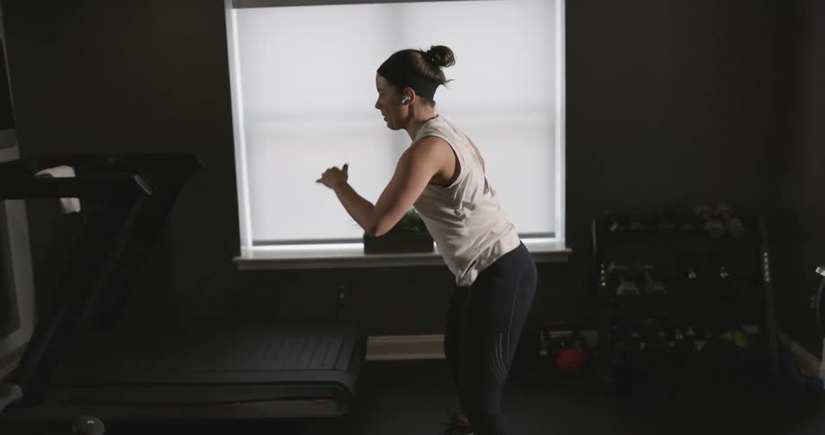 A woman is exercising in her home gym